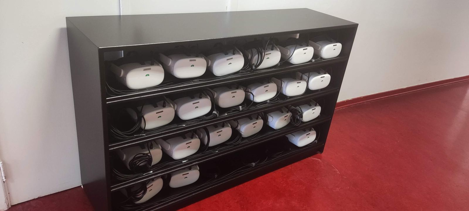 VR headsets charging on a rack, ready for a screening
